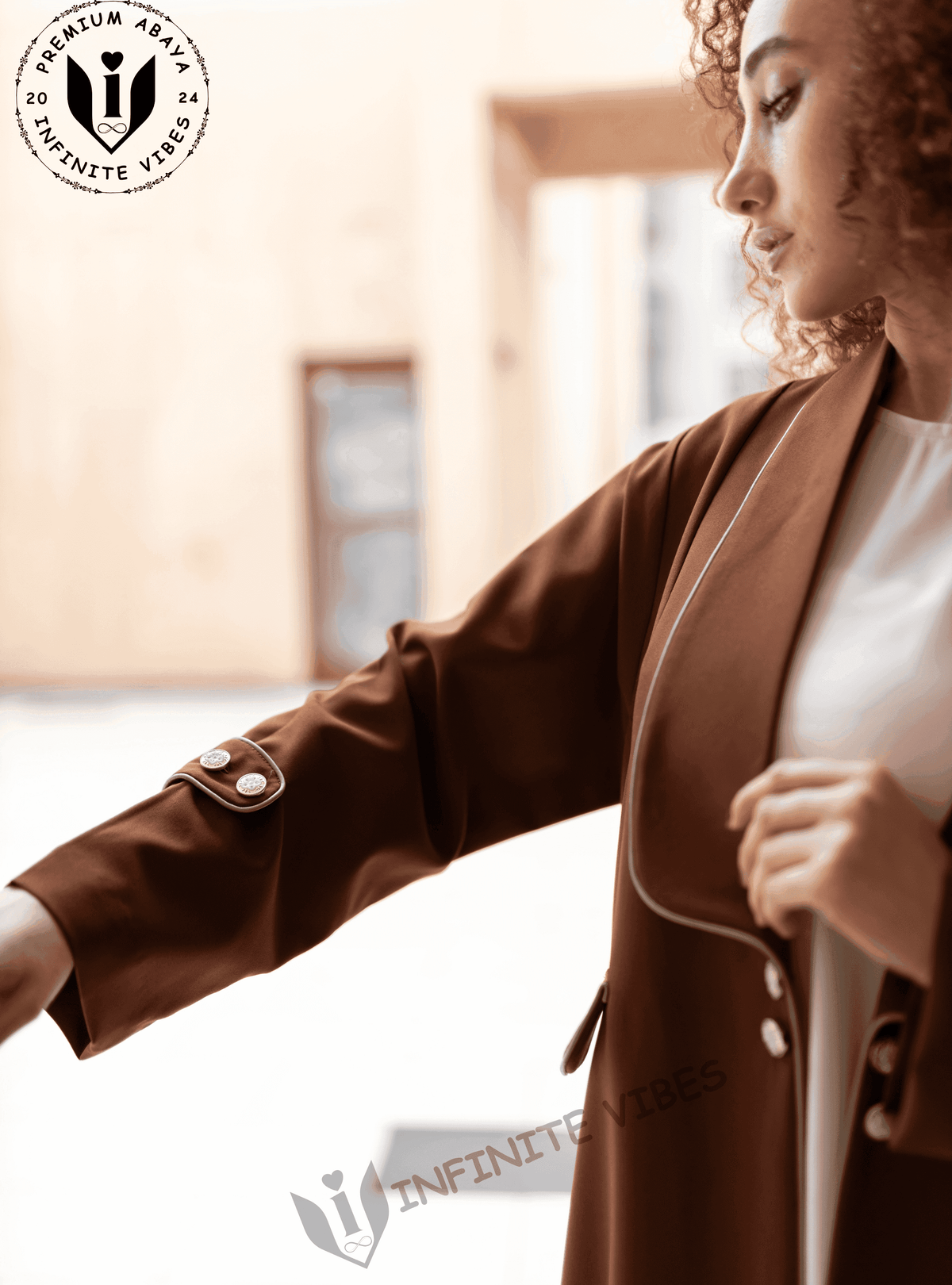 Woman wearing a brown designer abaya with button details on the sleeve, modest fashion