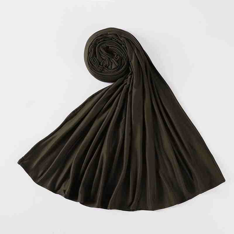 Folded black modest abaya fabric laid out on white background, luxury Islamic clothing