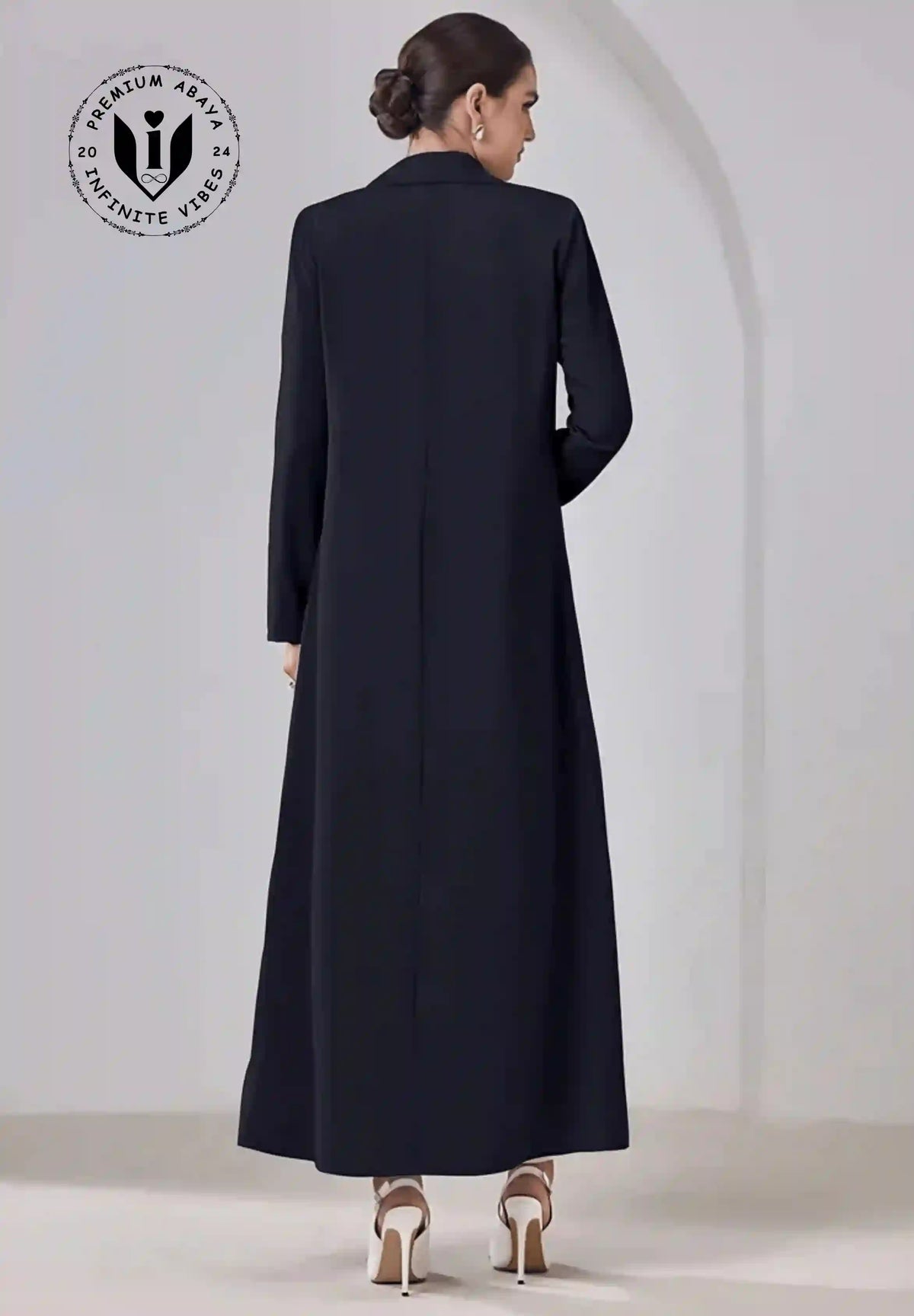 Back view of woman wearing a classic black premium abaya with long sleeves and heels
