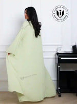 Woman in pistachio green chiffon abaya with crystal vine embroidery detail, modest fashion