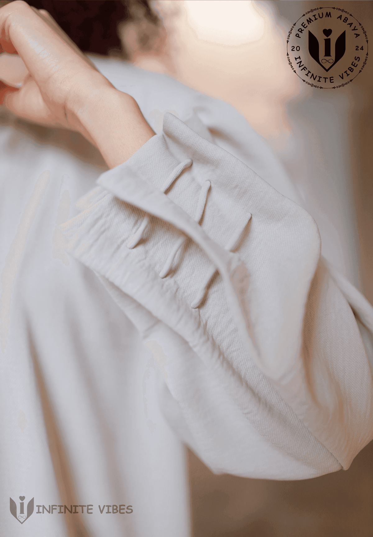 Close-up of dusty beige abaya sleeve with stitched details, modest fashion UAE