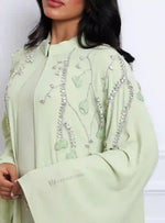 Light green embroidered abaya with crystal embellishments, modest UAE women's fashion.
