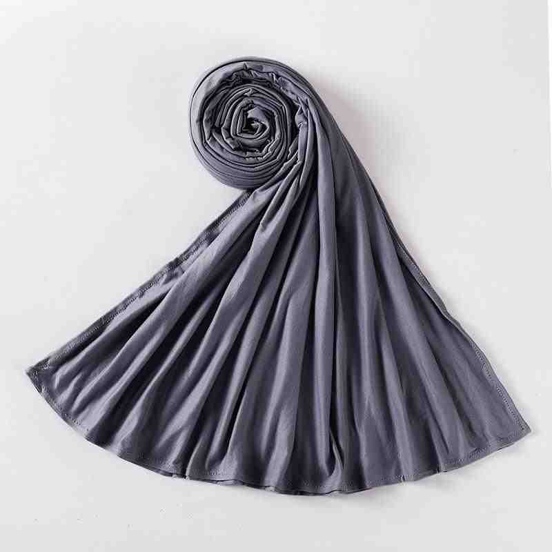 Rolled grey abaya fabric scarf on white background, luxury modest wear accessory