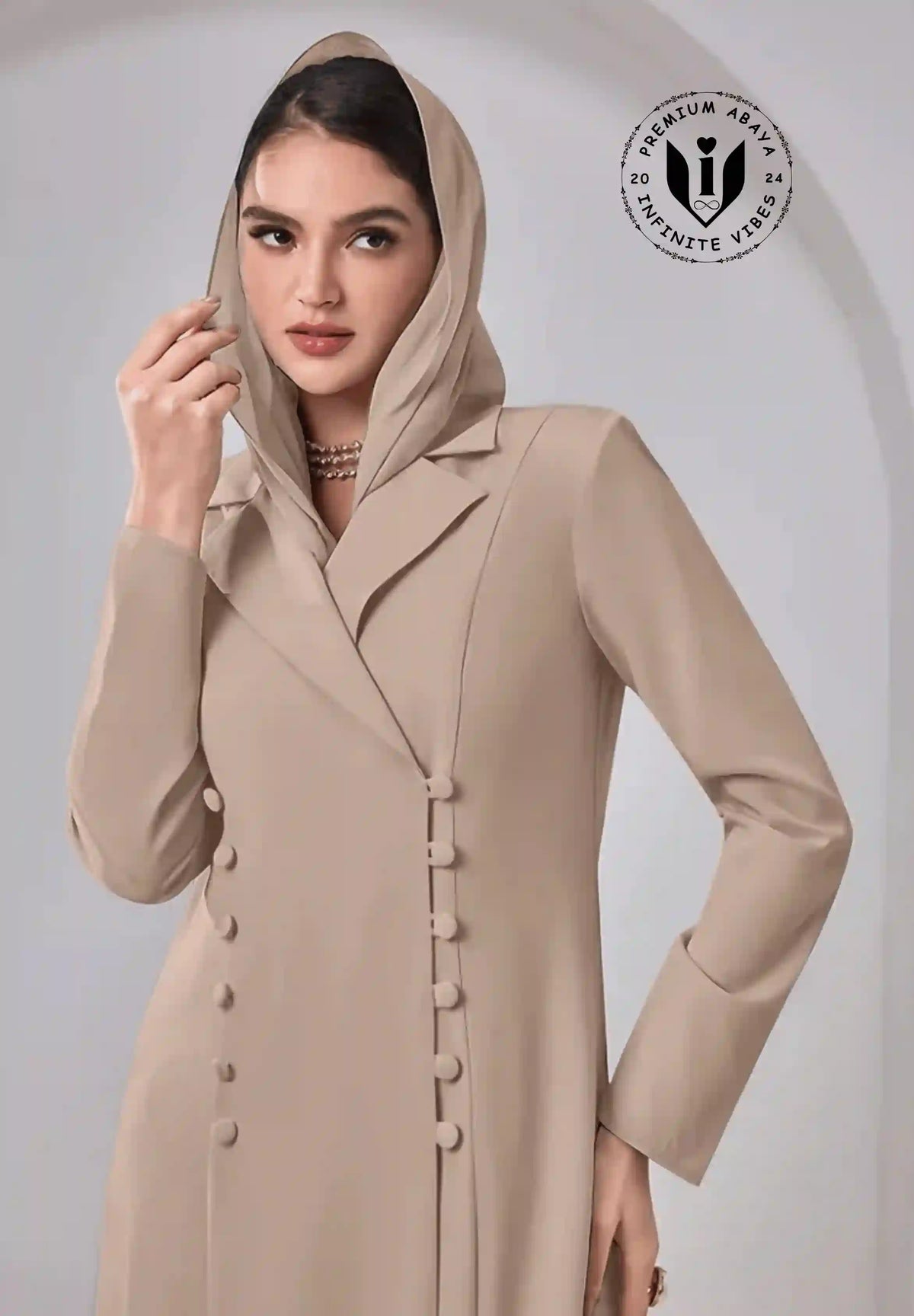 Elegant woman in luxury beige abaya with hood, button detailing, and modest fashion style