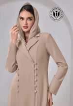 Elegant woman in luxury beige abaya with hood, button detailing, and modest fashion style