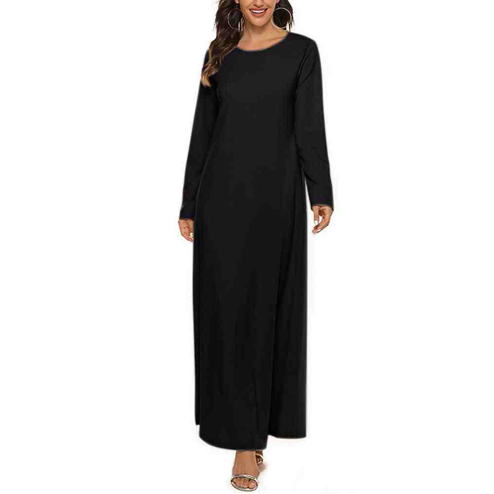 Woman wearing black long-sleeve abaya, modest fashion, UAE style, white background