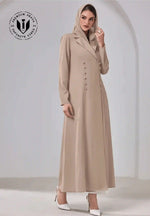 Elegant beige abaya with buttons, long sleeves, and hijab, styled for women in UAE.