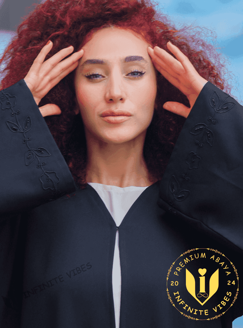 Woman wearing a black designer abaya with intricate handwork embroidery on sleeves