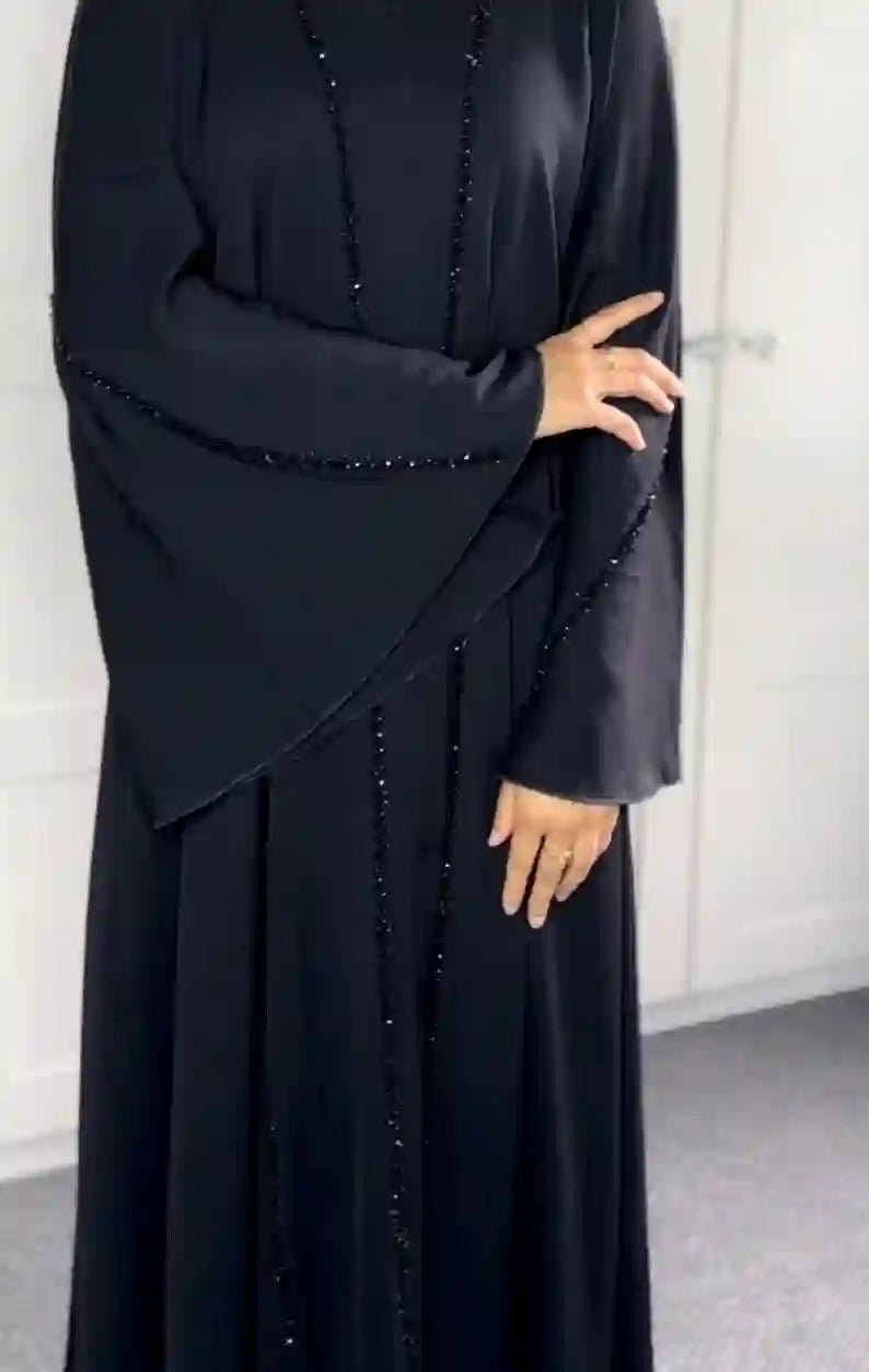 Elegant black abaya with bead detailing, wide sleeves, modest fashion style