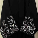 Black abaya with white floral embroidery on sleeves, modest fashion, designer abaya UAE