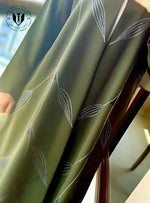 Olive green designer abaya with white abstract leaf patterns, luxury modest fashion