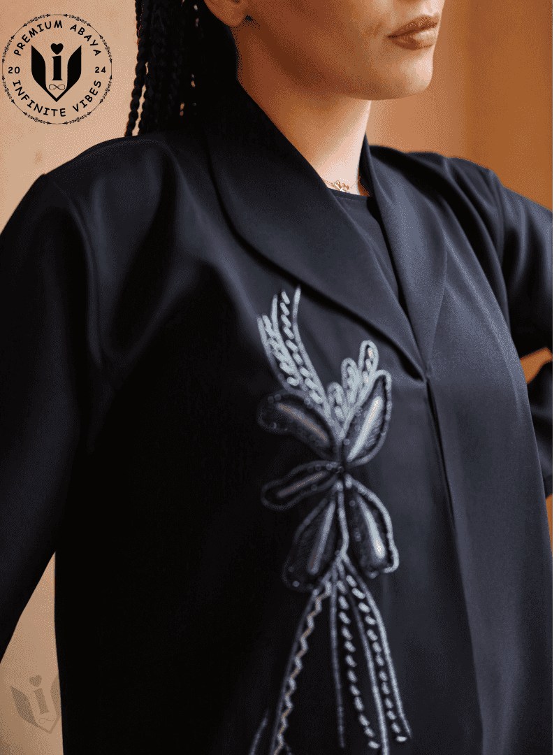 Elegant black abaya with handwork embroidery and lapel collar, premium modest fashion.