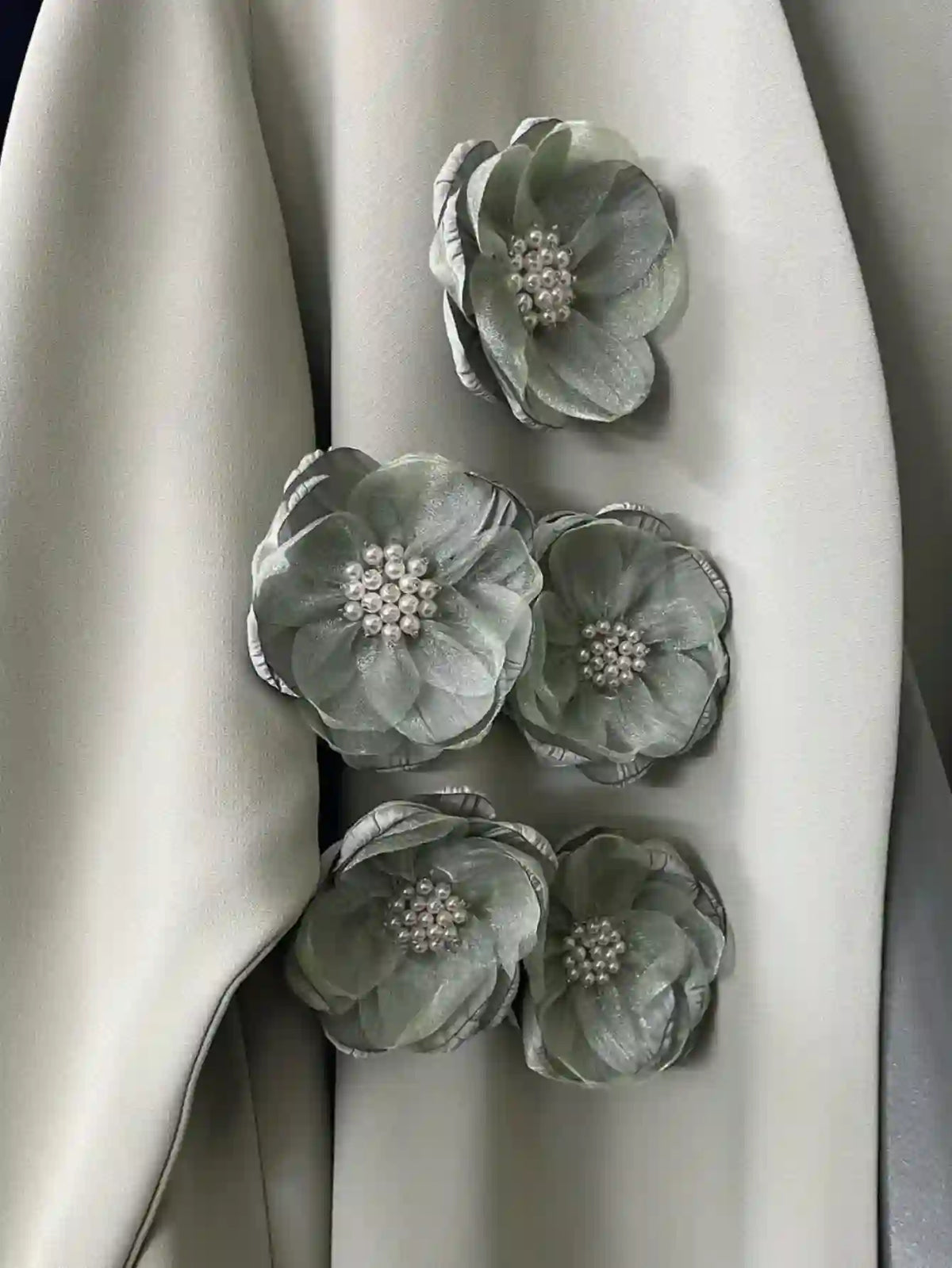 Close-up of handmade bridal abaya sleeve with gray floral embellishments and pearl centers