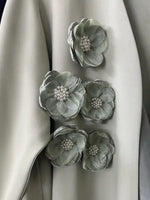 Close-up of handmade bridal abaya sleeve with gray floral embellishments and pearl centers