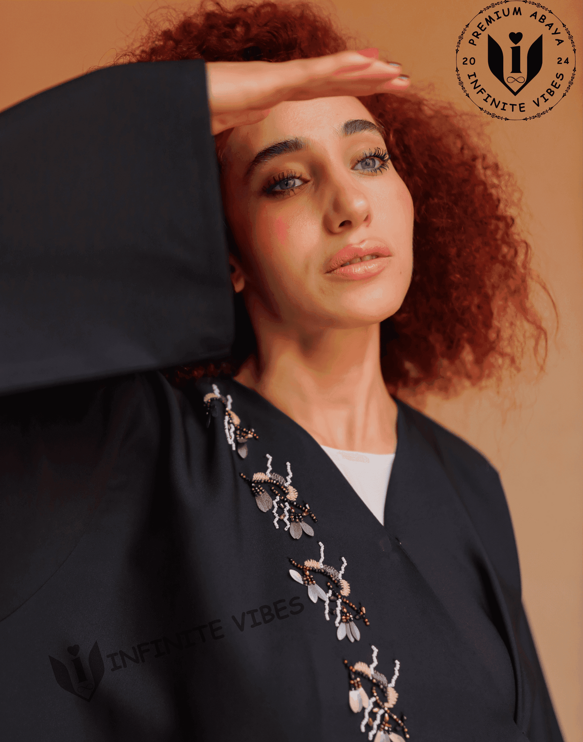 Woman wearing a black designer abaya with beaded floral embroidery, modest fashion