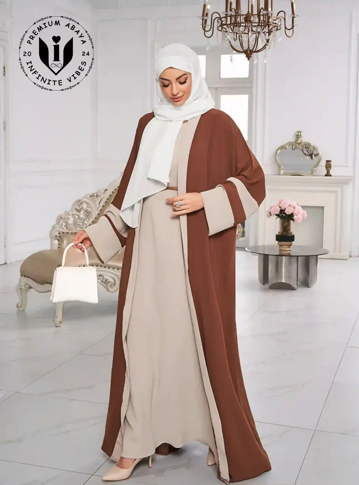 Woman wearing beige abaya with brown open front and white hijab in elegant room