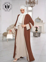 Woman wearing beige abaya with brown open front and white hijab in elegant room