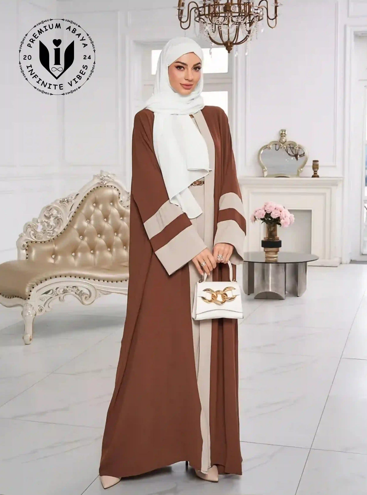 Woman in a brown and beige open style abaya with white hijab, luxury modest fashion in elegant room.