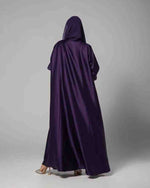 Back view of a woman in a deep purple satin hooded abaya, modest fashion style
