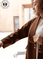 Woman wearing a brown designer abaya with button details on the sleeve, modest fashion