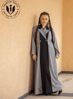 Woman wearing premium designer grey and black abaya with double-breasted buttons