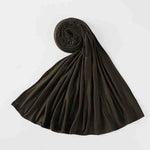 Folded black modest abaya fabric laid out on white background, luxury Islamic clothing