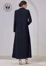 Back view of woman wearing a classic black premium abaya with long sleeves and heels