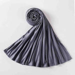 Rolled grey abaya fabric scarf on white background, luxury modest wear accessory