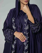 Elegant navy blue abaya with silver embroidery, featuring a hood and modest design.