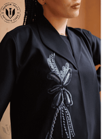 Elegant black abaya with handwork embroidery and lapel collar, premium modest fashion.