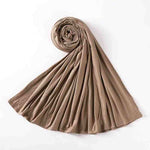 Neutral beige hijab scarf laid on white background, modest fashion accessory, UAE style